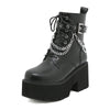 Statement platform boots featuring metal chain decoration and edgy black design