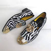 Stylish velvet shoes with a gold toe, perfect for special occasions.