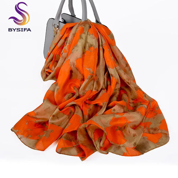 Model showcasing Autumn Whisper silk scarf in a chic urban setting, exuding elegance.