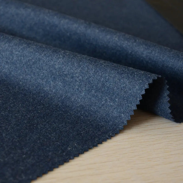 Close-up of the luxurious blue-grey wool flannel fabric of the suit.