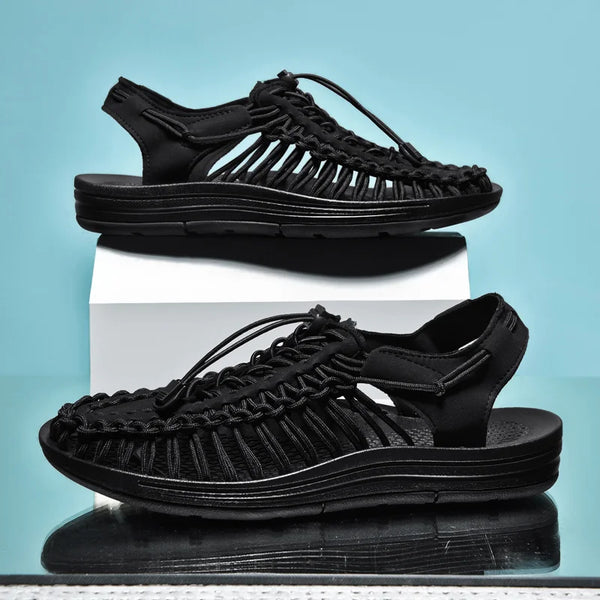 Slip-on breathable sandals featuring handwoven construction and flat heel
