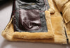 Luxury men's shearling leather bomber jacket in a stylish pose.