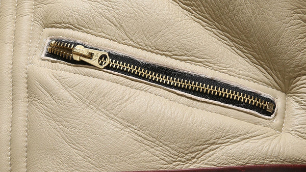 Close-up of the collar on the luxury men's shearling leather bomber jacket.