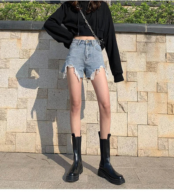 Loose fit high waisted shorts in premium denim with hand-finished distressed accents