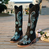 Embroidered mid-calf women's fashion boots with low wedge heel, slip-on design, and durable rubber outsole for comfort.