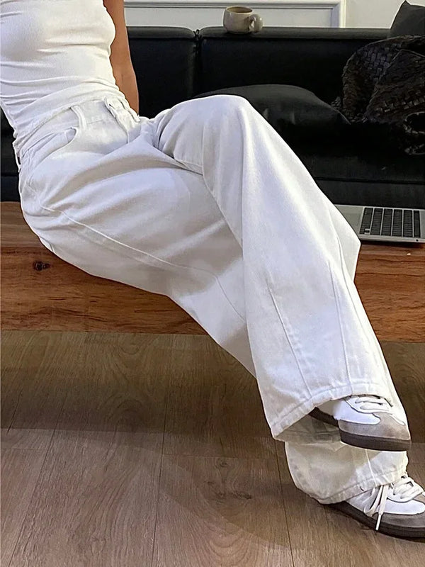 High waisted white jeans with wide leg style and decorative pocket appliqués
