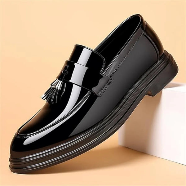 Formal black penny loafers with water-resistant construction and sophisticated tassel accents on glossy surface