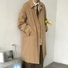 Chic Japanese vintage trench coat for men in black, featuring a single-breasted closure and stylish turn-down collar.