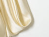 Dressy satin top with dimensional pleats and open back design