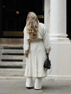 Sophisticated cream trench coat with classic collar and button-front closure detail