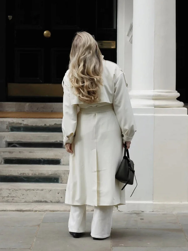 Sophisticated cream trench coat with classic collar and button-front closure detail