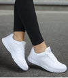 White running shoes with multi-color details and secure lace closure