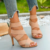 Fashion-forward teal stiletto heels with an open toe and zipper closure.