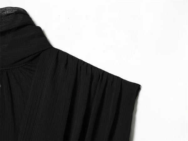 Detail view of pleated texture on sleeveless black top with ribbon