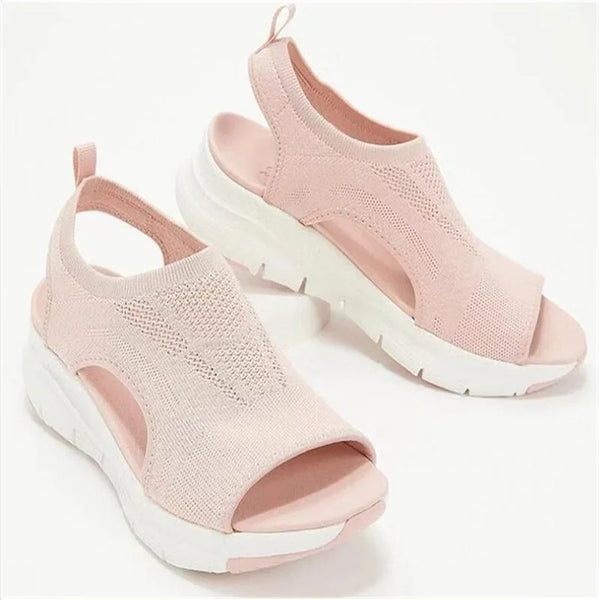 Woman walking in comfortable mesh wedge platform sandals on boardwalk
