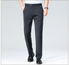 Charcoal gray business pants with flat front styled for morning presentation look
