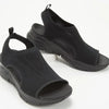 Detail of cloud-like soft mesh material and open toe design on wedge platform sandals