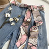 Chic fabric belt for women with geometric design, versatile for dresses, jeans, or as a scarf and headband accessory.