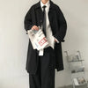 Chic Japanese vintage trench coat for men in black, featuring a single-breasted closure and stylish turn-down collar.