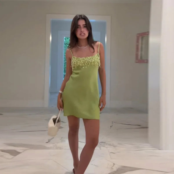 Dazzling emerald cocktail dress with all-over sequins and playful fringe hemline