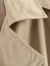 Women's double-breasted trench featuring belt detail in neutral tone