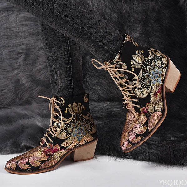 Women's embroidered ankle boots with golden floral patterns and secure lace-up closure