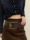 Vintage wide belt for women in black faux leather with metal buckle, perfect for casual or formal wear. Stylish accessory.