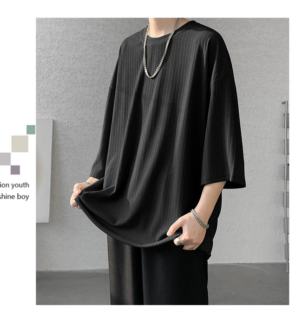 Striped summer tee folded neatly, highlighting machine washable care instructions.