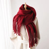 Stylish winter wrap in soft ivory, featuring plush fabric.
