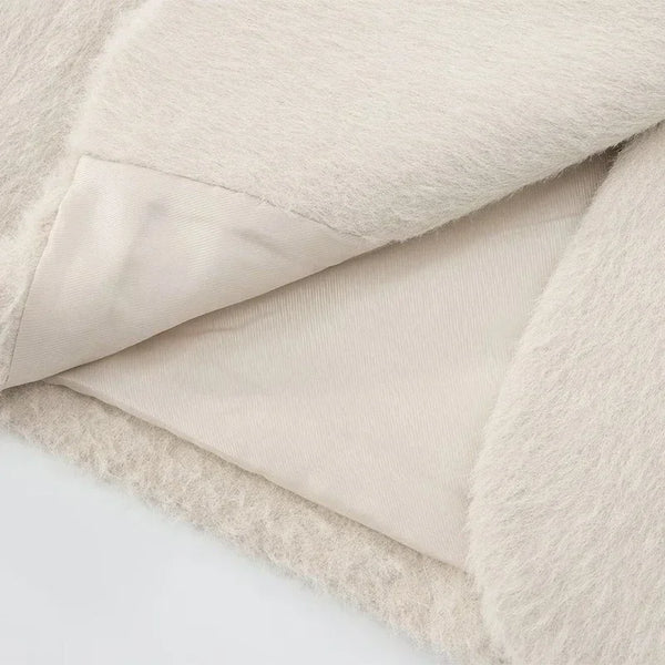 Side profile of woman wearing creamy white mohair blazer with classic collar styling