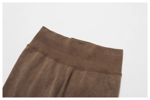 Rust orange high waist yoga pants made from breathable fabric.