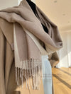 Warm winter shawl in soft gray, perfect for draping over shoulders for added elegance.