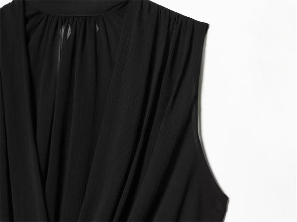 Women's black top with elegant pleats and delicate ribbon accent