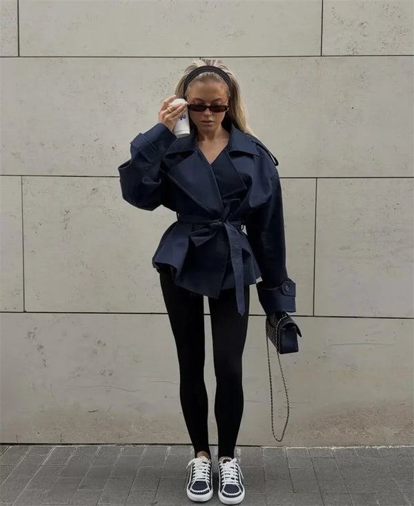 Short length trench coat with double-breasted front and waist sash