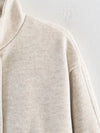 Loose-fit belted outerwear in neutral shade perfect for fall wardrobe