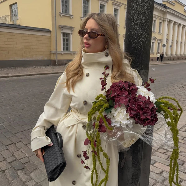 Cream colored outerwear trench coat with long length extending past hips