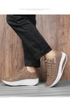 Side angle of white platform wedge sneakers showing lift