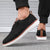 Detail of breathable knitted mesh on men's gray walking shoes with classic lace closure