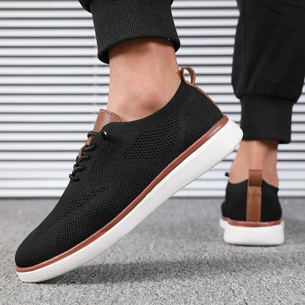 Detail of breathable knitted mesh on men's gray walking shoes with classic lace closure
