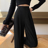 Detail shot of functional side pockets and premium polyester fabric texture on wide leg trousers