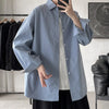 Oversized long sleeve casual shirt for men and women, featuring a Mandarin collar and single-breasted closure in solid color.