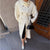 Timeless cream long trench coat with classic silhouette and modern appeal