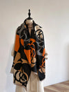 Luxury cashmere-blend women's winter scarf in elegant floral pattern.
