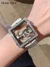 Timeless Pulse watch with transparent case and stainless steel body.