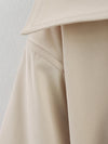 Double-breasted trench coat with elegant collar and belt accent
