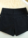Detail shot of silver rivets and decorative hardware on black lace-up denim shorts for summer festivals