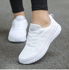Breathable white sports footwear with rainbow accents for active lifestyle