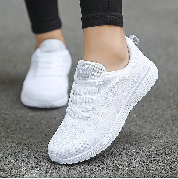 Breathable white sports footwear with rainbow accents for active lifestyle