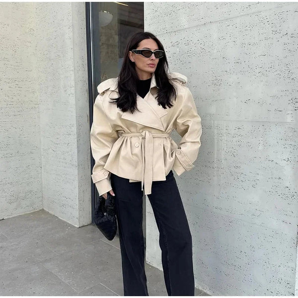 Women's trench coat featuring double-breasted closure and waist sash