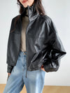 Model wearing the cropped leather jacket for women in a spring setting.